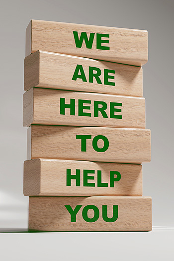 Vertical stack of six natural wood blocks spelling out “We are here to help you
